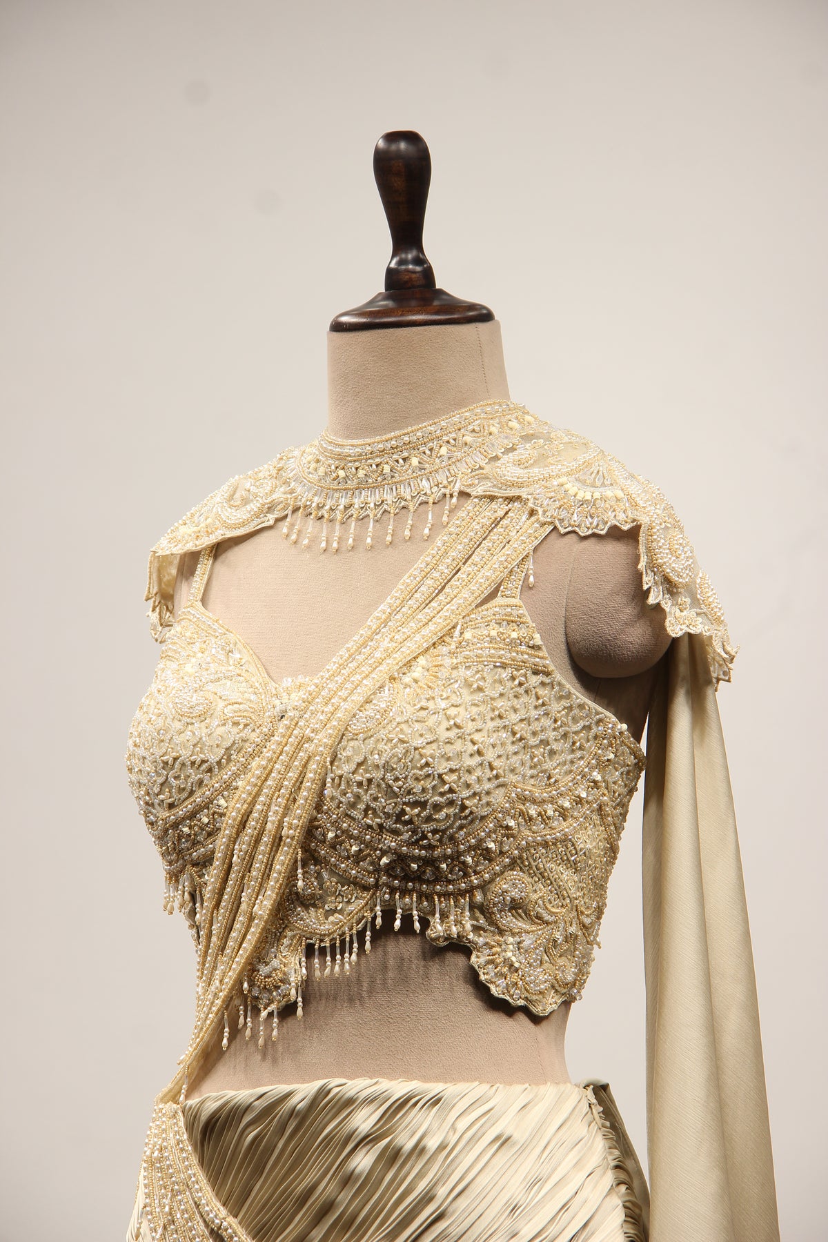 Ivory Satin Drape Skirt Lehenga with Bead & Pearl Handwork Crop Top – side close-up, with cape