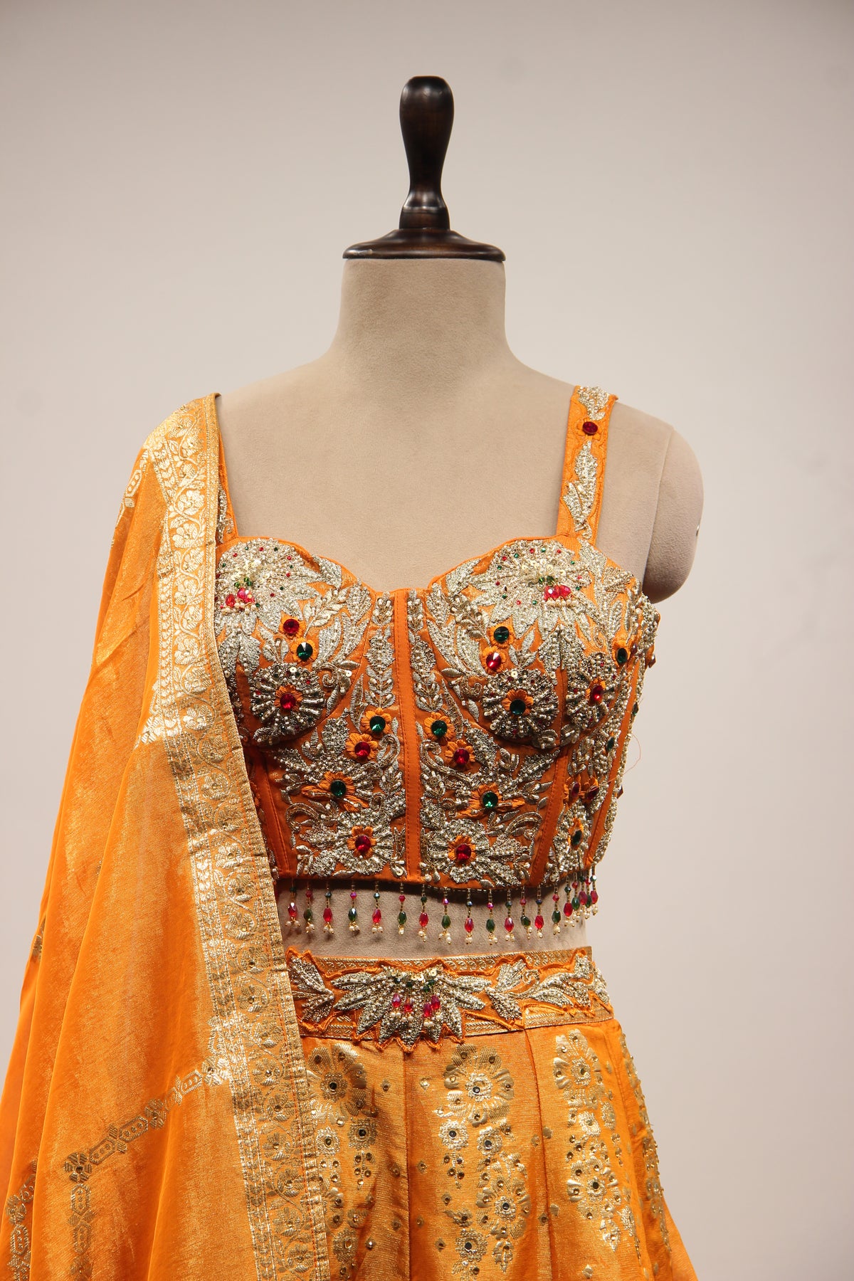 Tissue Lehenga with Stone & Zari Handwork Corset Blouse in Orange – front close-up