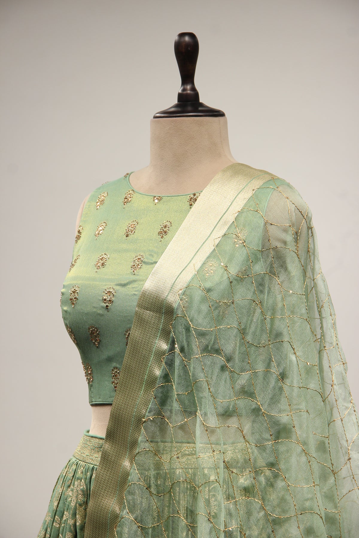 Green Banarsi Brocade Lehenga with Stone & Tassel Handwork Halter Neck
