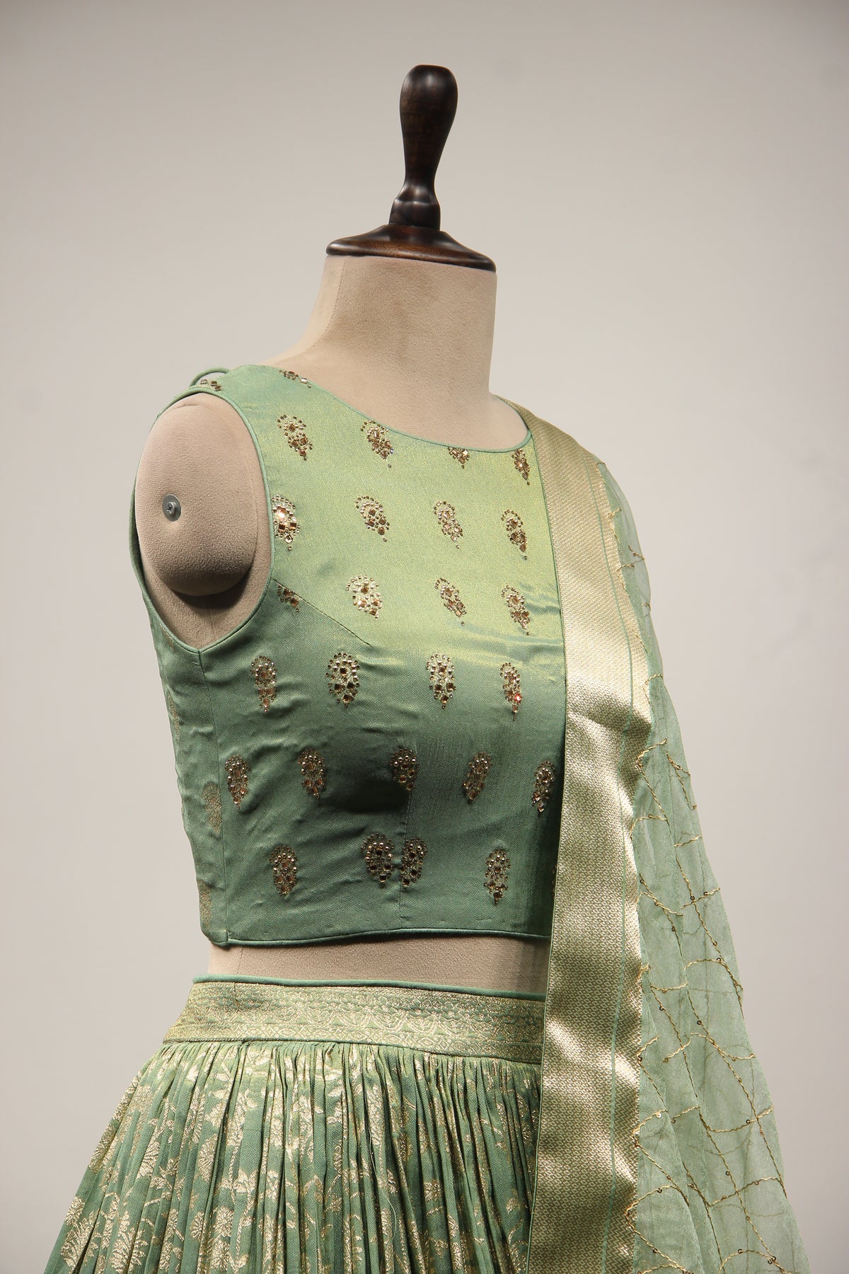 Green Banarsi Brocade Lehenga with Stone & Tassel Handwork Halter Neck