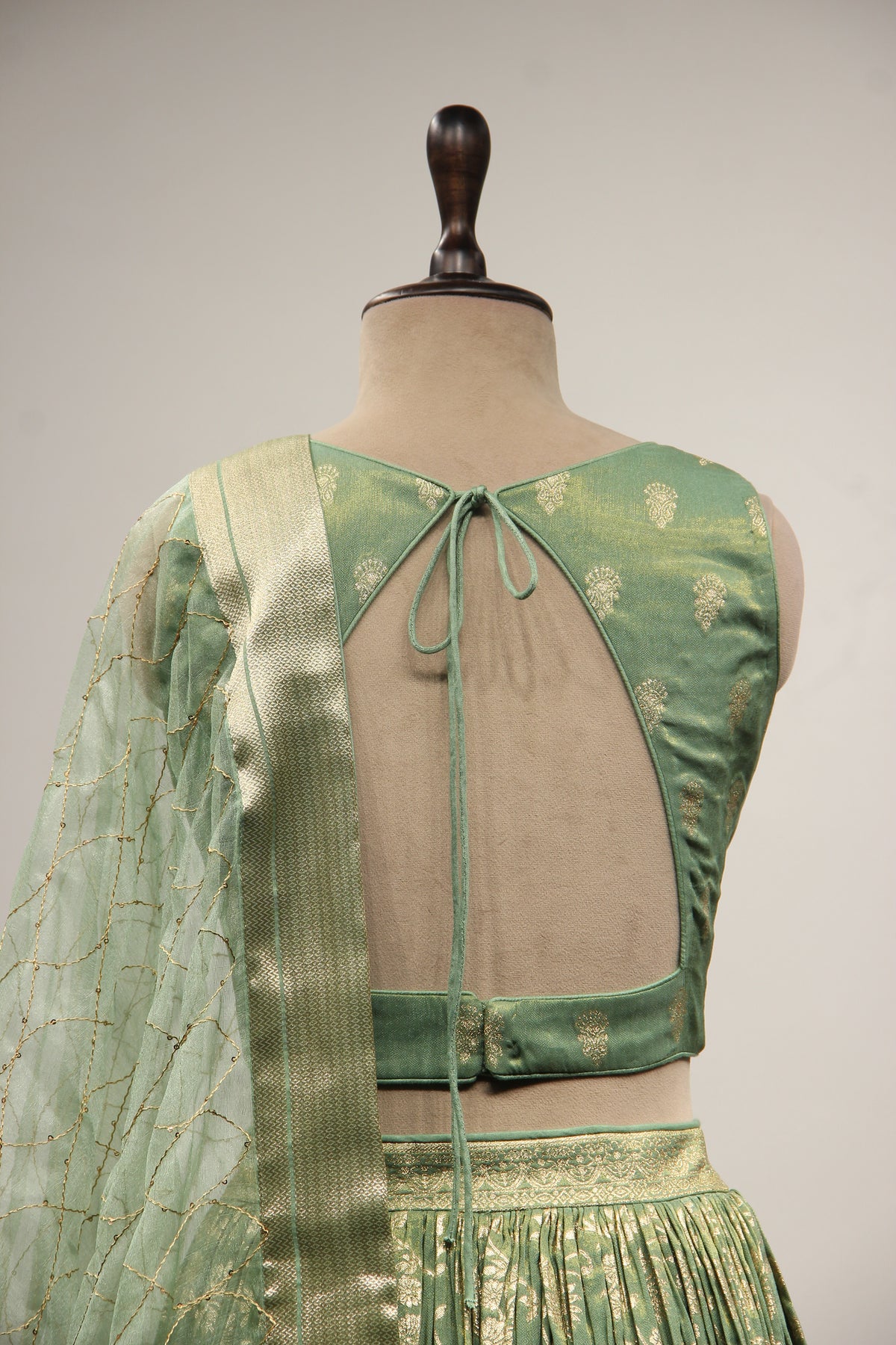 Green Banarsi Brocade Lehenga with Stone & Tassel Handwork Halter Neck
