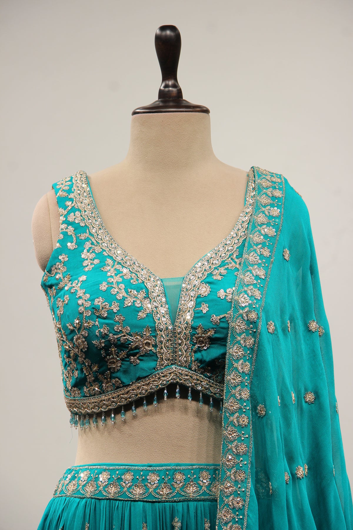 Georgette Lehenga with Zari & Sequin Handwork Plunge V-Neck Crop Top in Green – front close-up