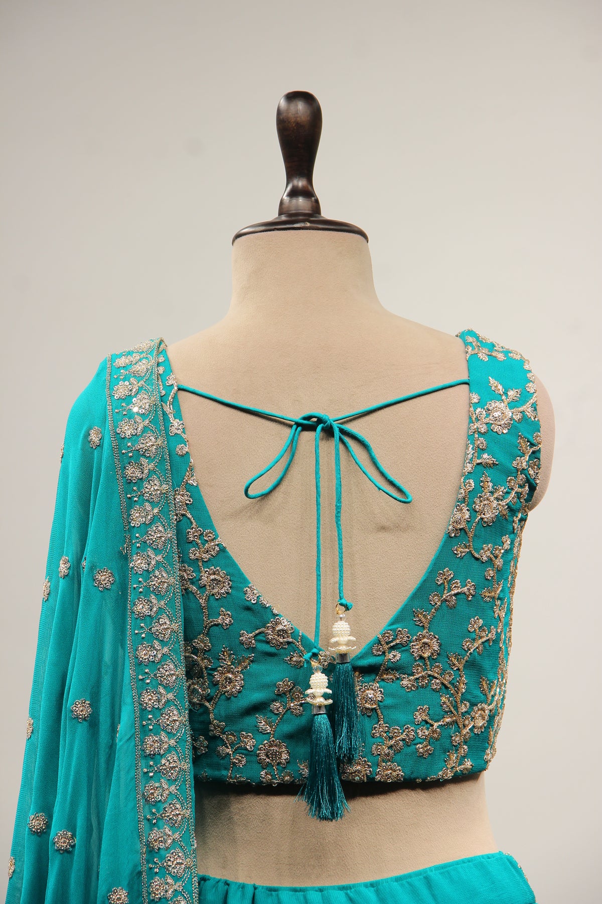 Georgette Lehenga with Zari & Sequin Handwork Plunge V-Neck Crop Top in Green – back close-up