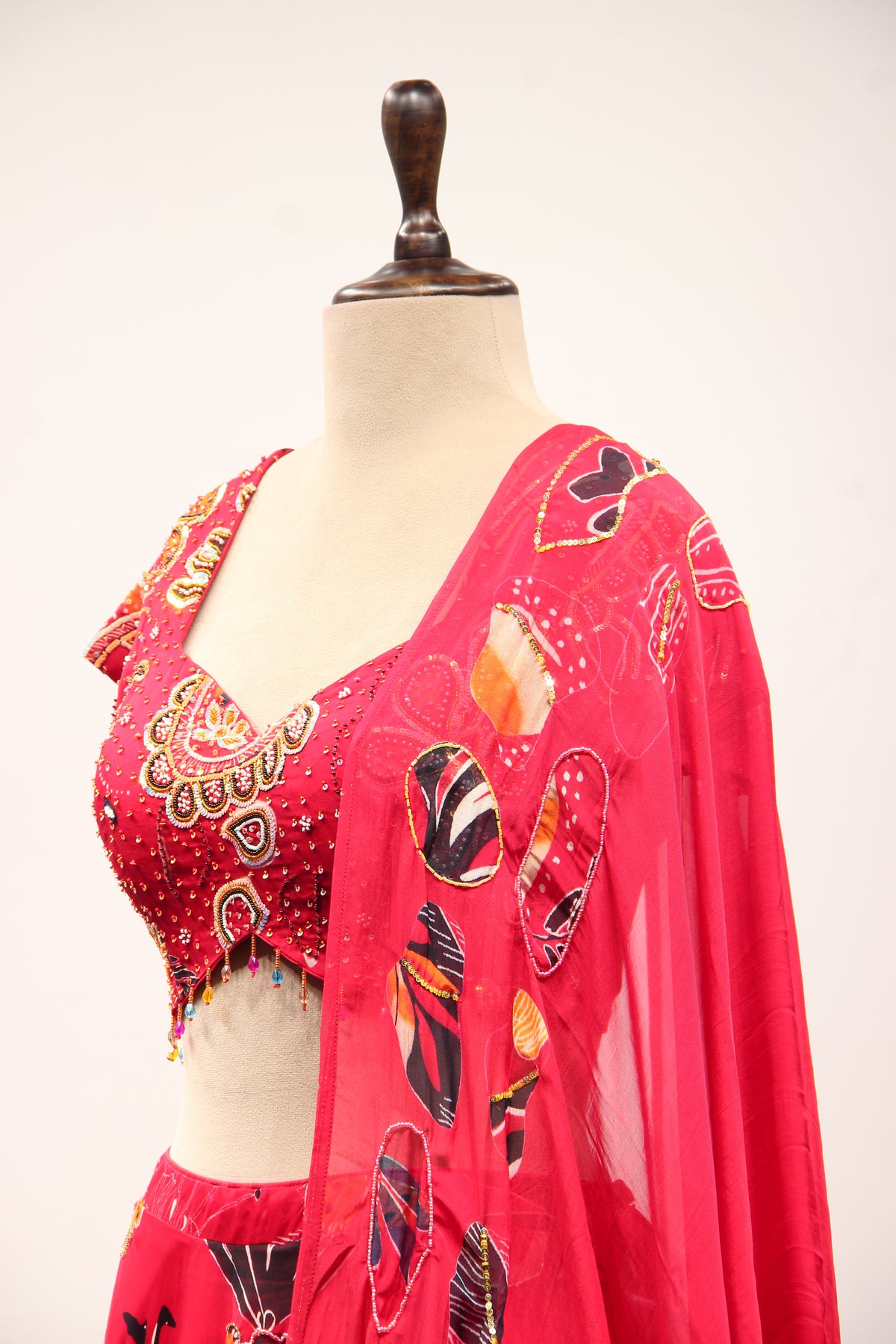 Red Organza Lehenga with Printed & Cut Dana Handwork Cap Sleeve Top – side close-up