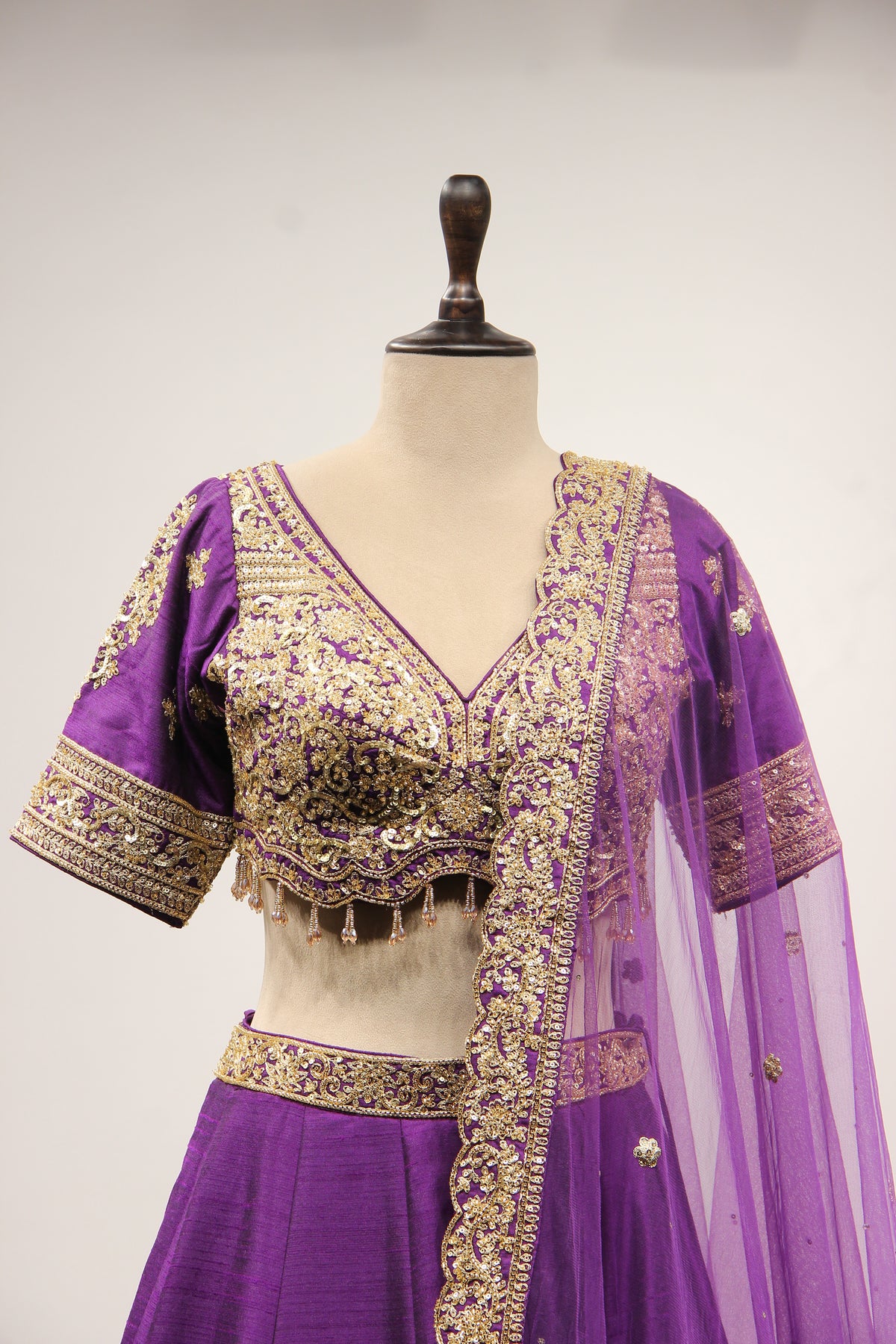 Dupion Lehenga with Zari & Sequin Handwork Half Sleeve V-Neck Crop Top in Purple – front close-up