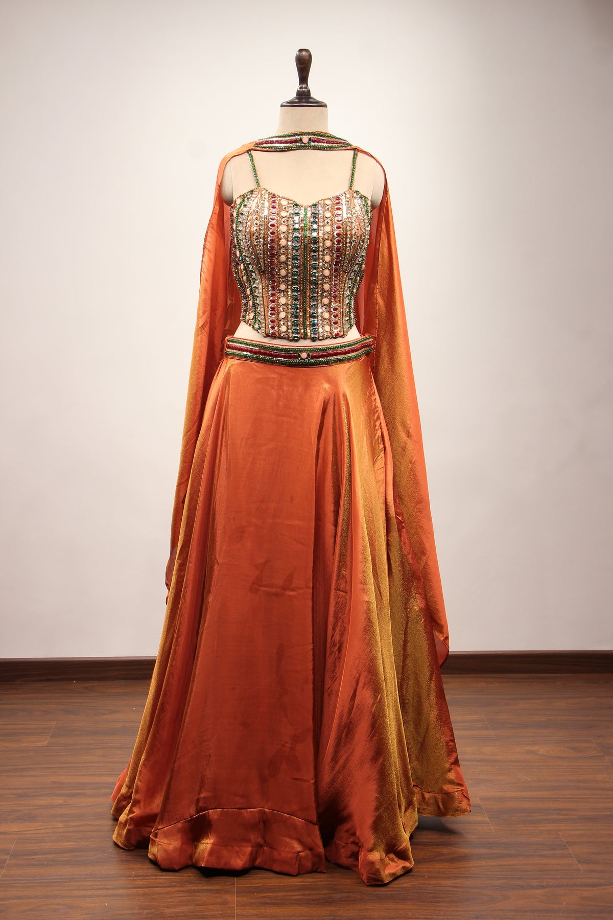 Rust Shimmer Tissue Corset Lehenga in Hand Embroidery & Stone Handwork – front view