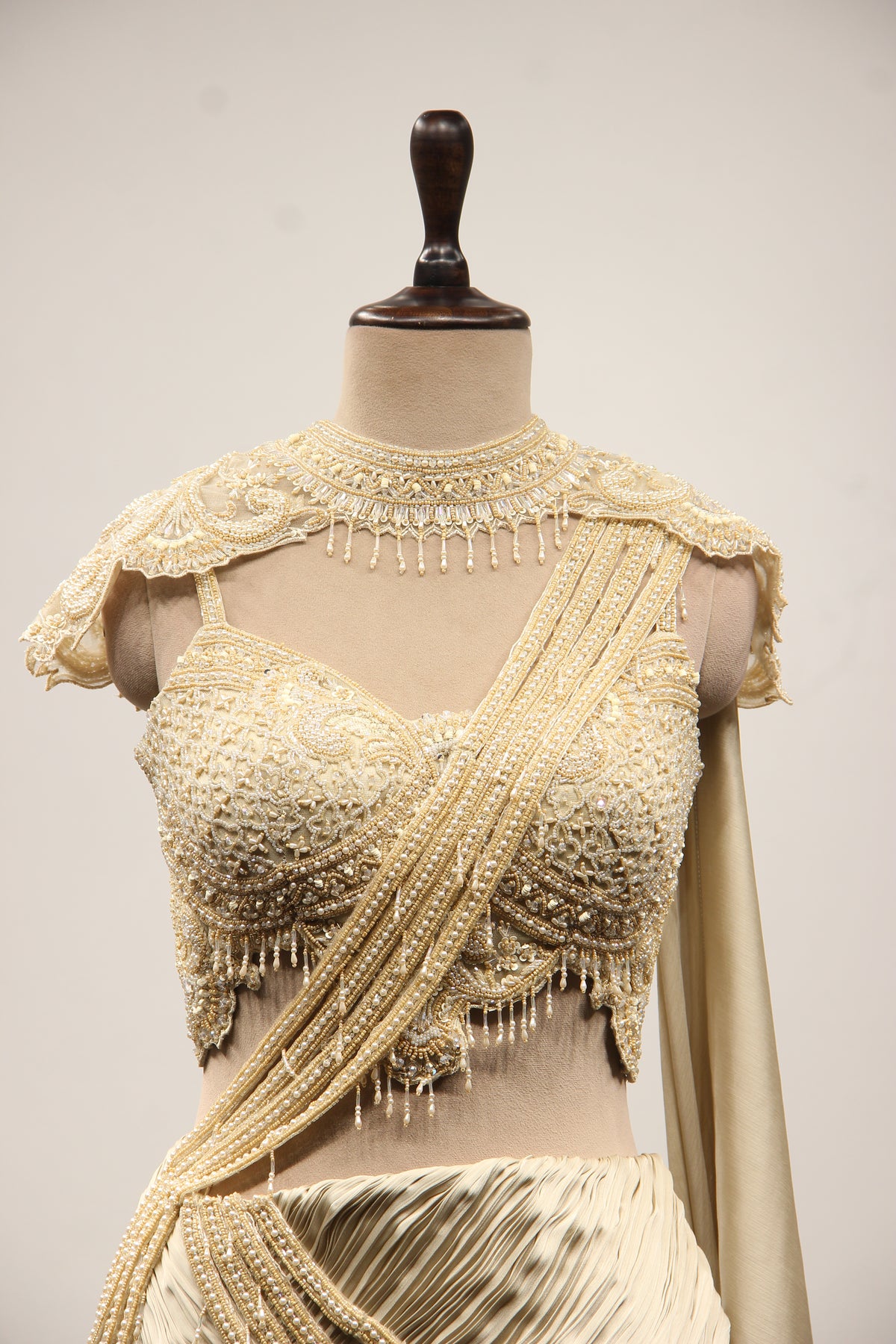 Ivory Satin Drape Skirt Lehenga with Bead & Pearl Handwork Crop Top – front close-up, with cape