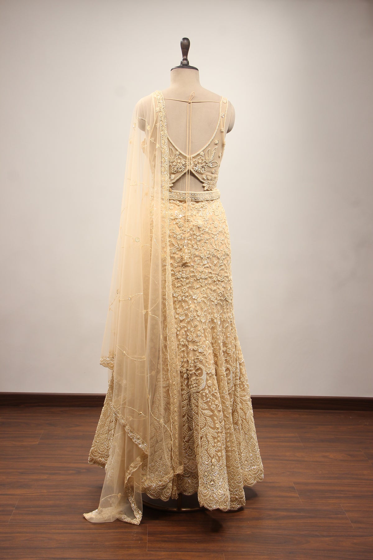 Net Mermaid Lehenga with Sequin & Cut Dana Handwork and Floral Bodice in Gold – back view