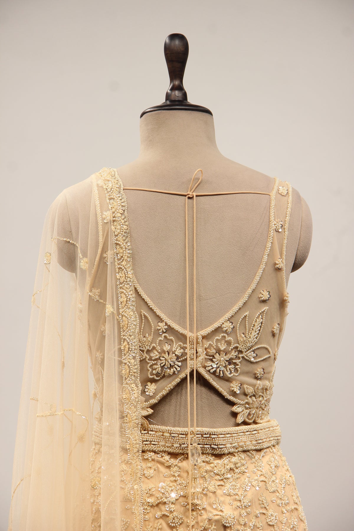 Net Mermaid Lehenga with Sequin & Cut Dana Handwork and Floral Bodice in Gold – back close-up