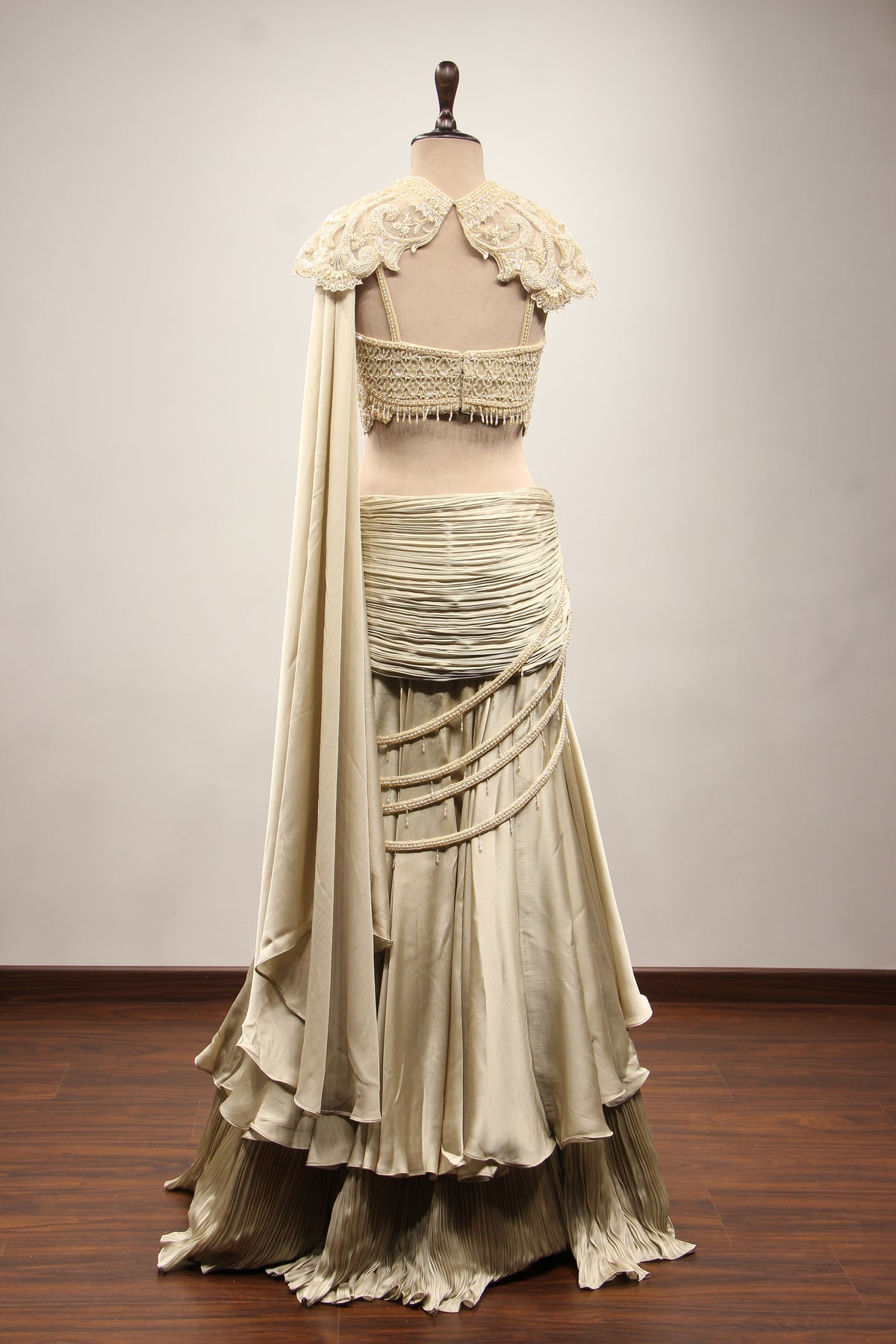 Ivory Satin Drape Skirt Lehenga with Bead & Pearl Handwork Crop Top – back view, with cape