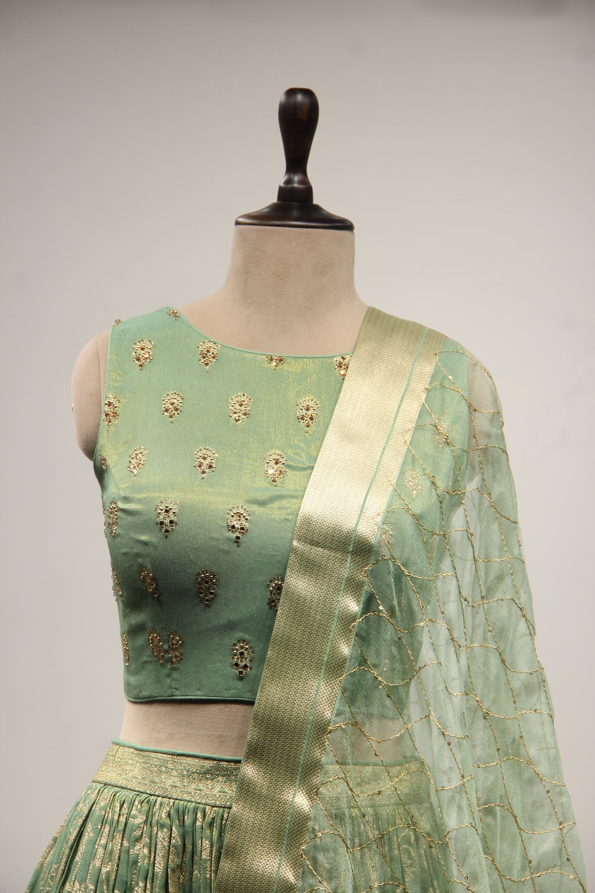 Green Banarsi Brocade Lehenga with Stone & Tassel Handwork Halter Neck