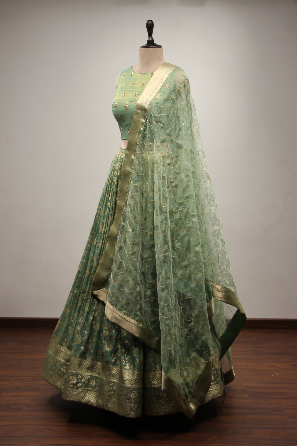 Green Banarsi Brocade Lehenga with Stone & Tassel Handwork Halter Neck