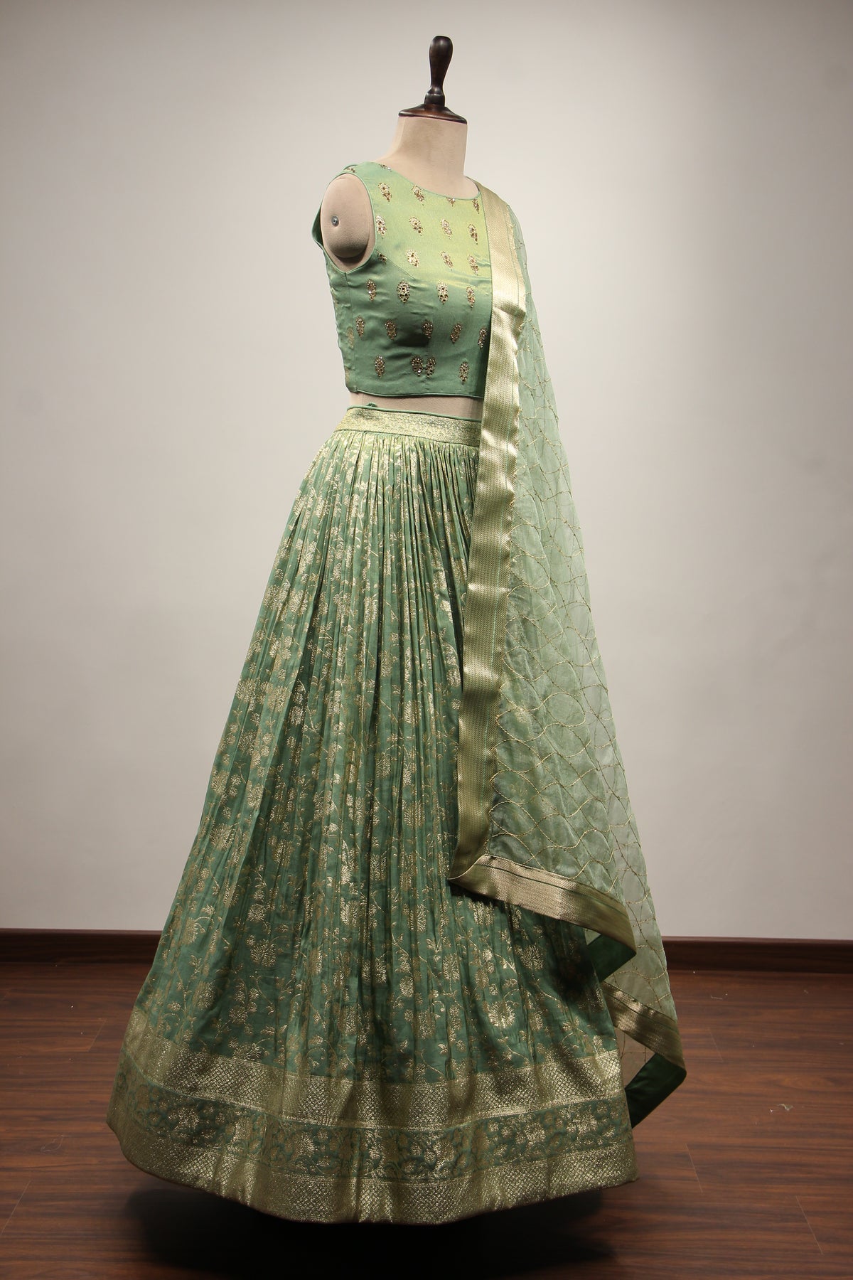 Green Banarsi Brocade Lehenga with Stone & Tassel Handwork Halter Neck