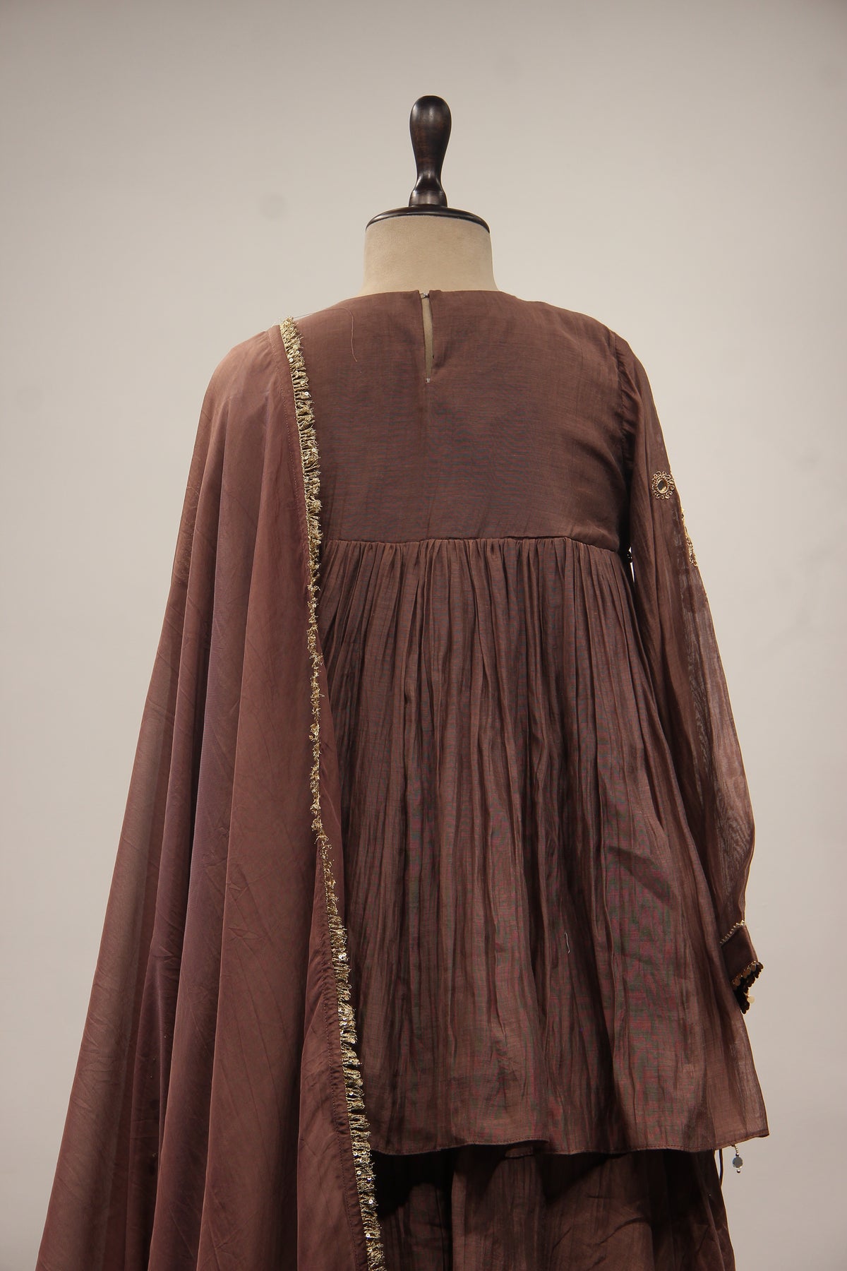 Chanderi Peplum Sharara Suit with Sequin & Zari Handwork Yoke in Brown – back close-up