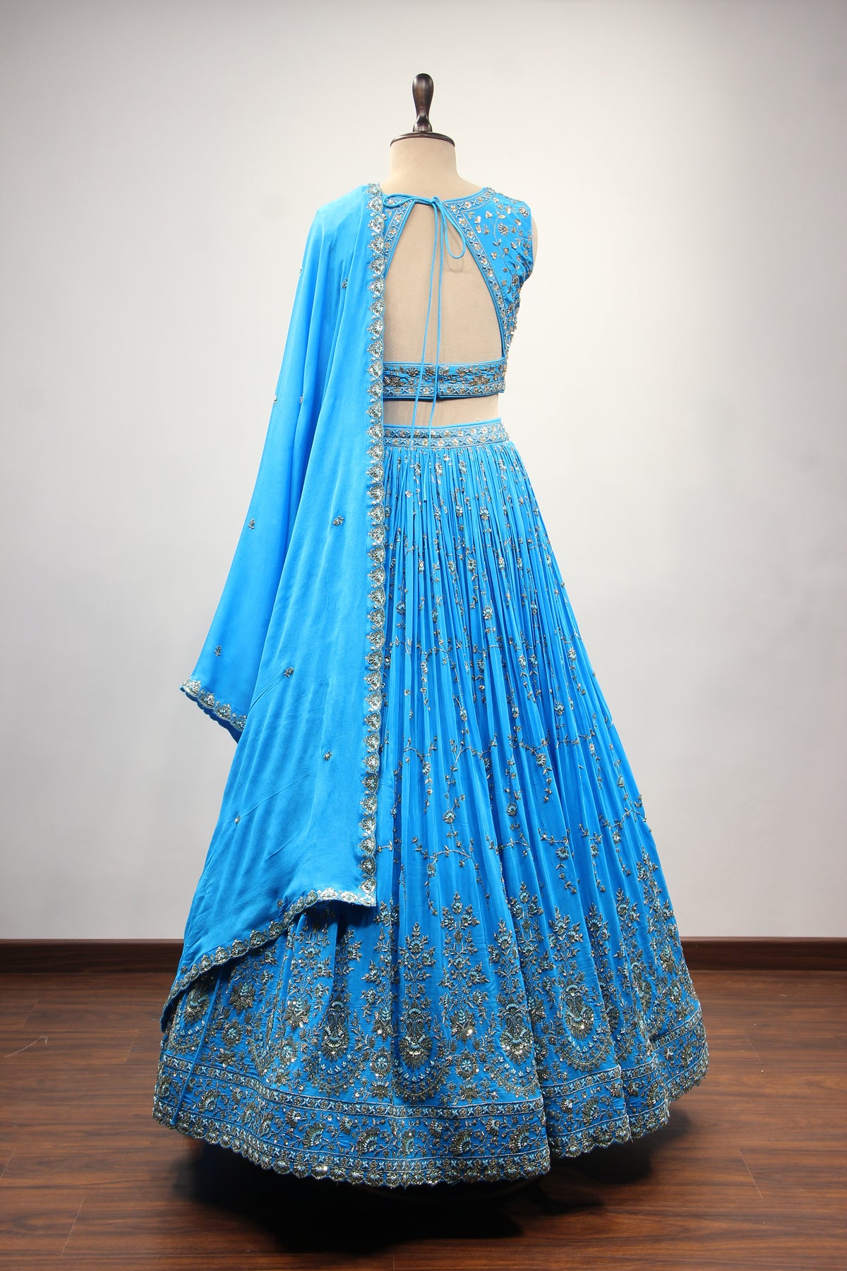 Turquoise Crepe Crop Top Lehenga in Hand Embroidery & Zardozi Handwork – back view