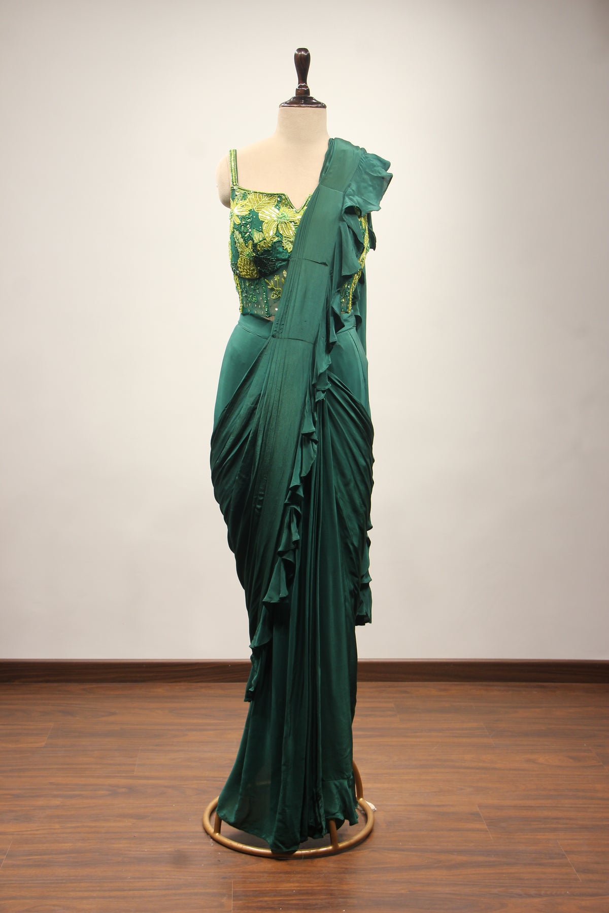 Bottle Green Crepe Drape Saree with Printed Cut Dana Handwork Corset – front view