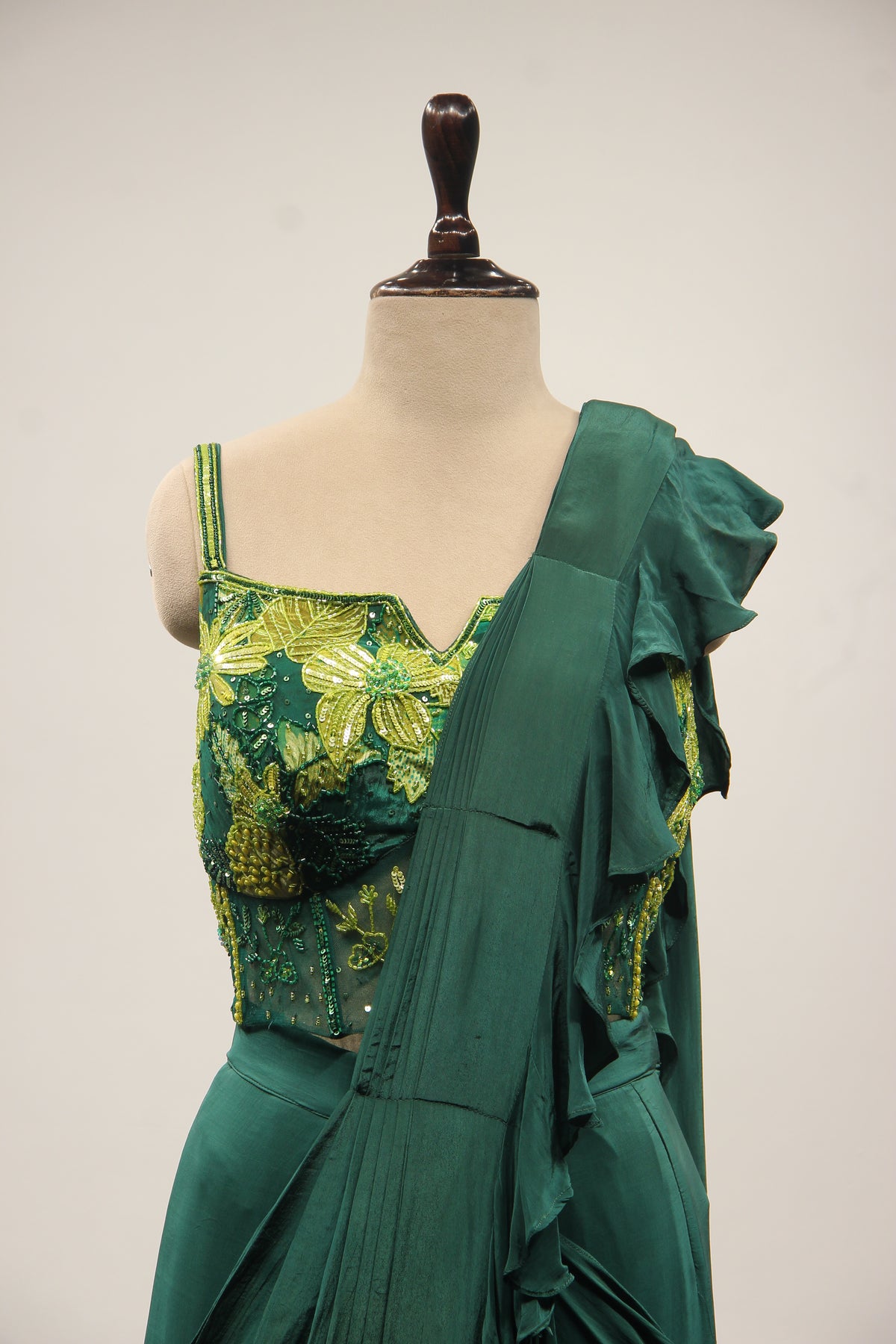Bottle Green Crepe Drape Saree with Printed Cut Dana Handwork Corset – front close-up