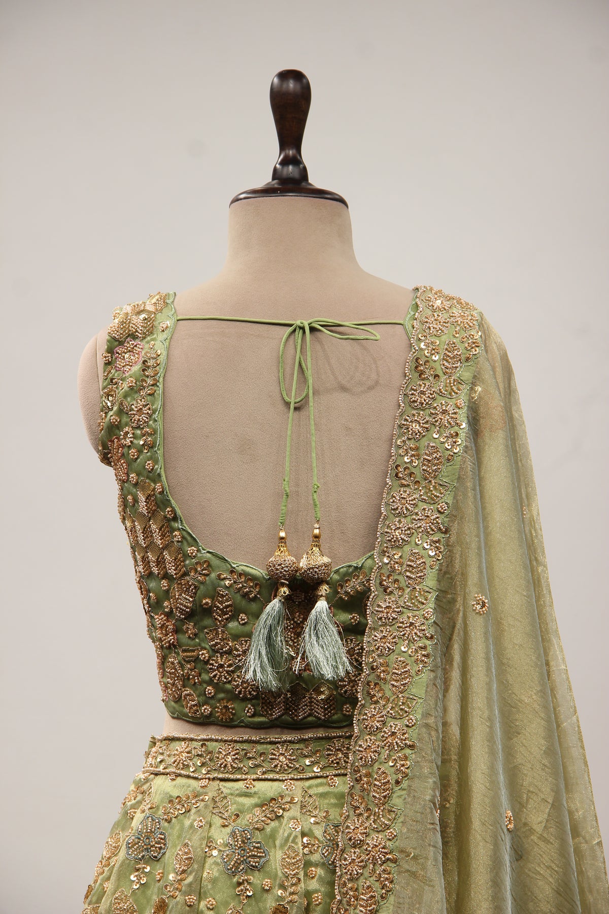 Green Shimmer Organza Lehenga with Bead & Zari Handwork Crop Top – back close-up
