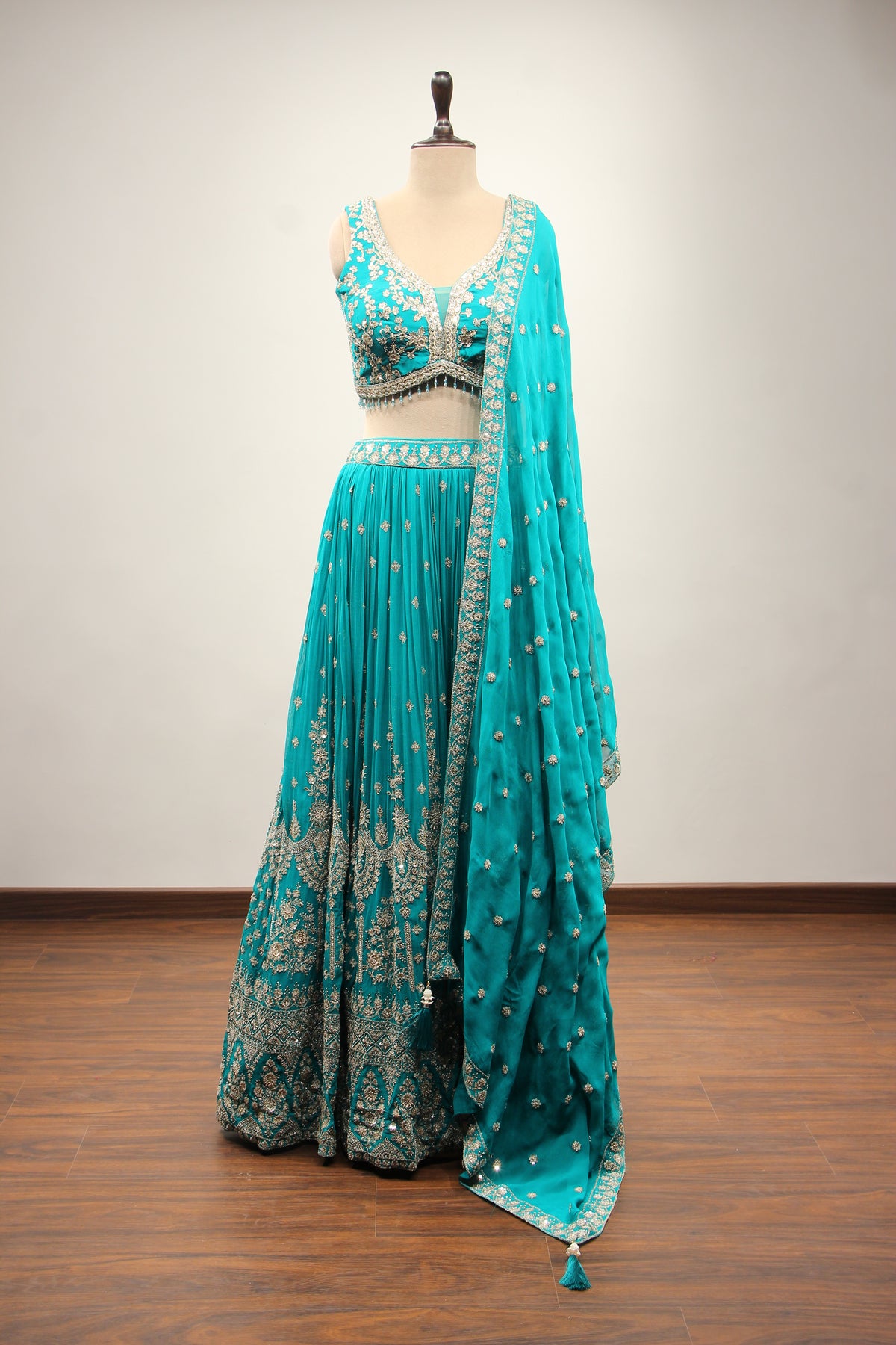 Georgette Lehenga with Zari & Sequin Handwork Plunge V-Neck Crop Top in Green – front view
