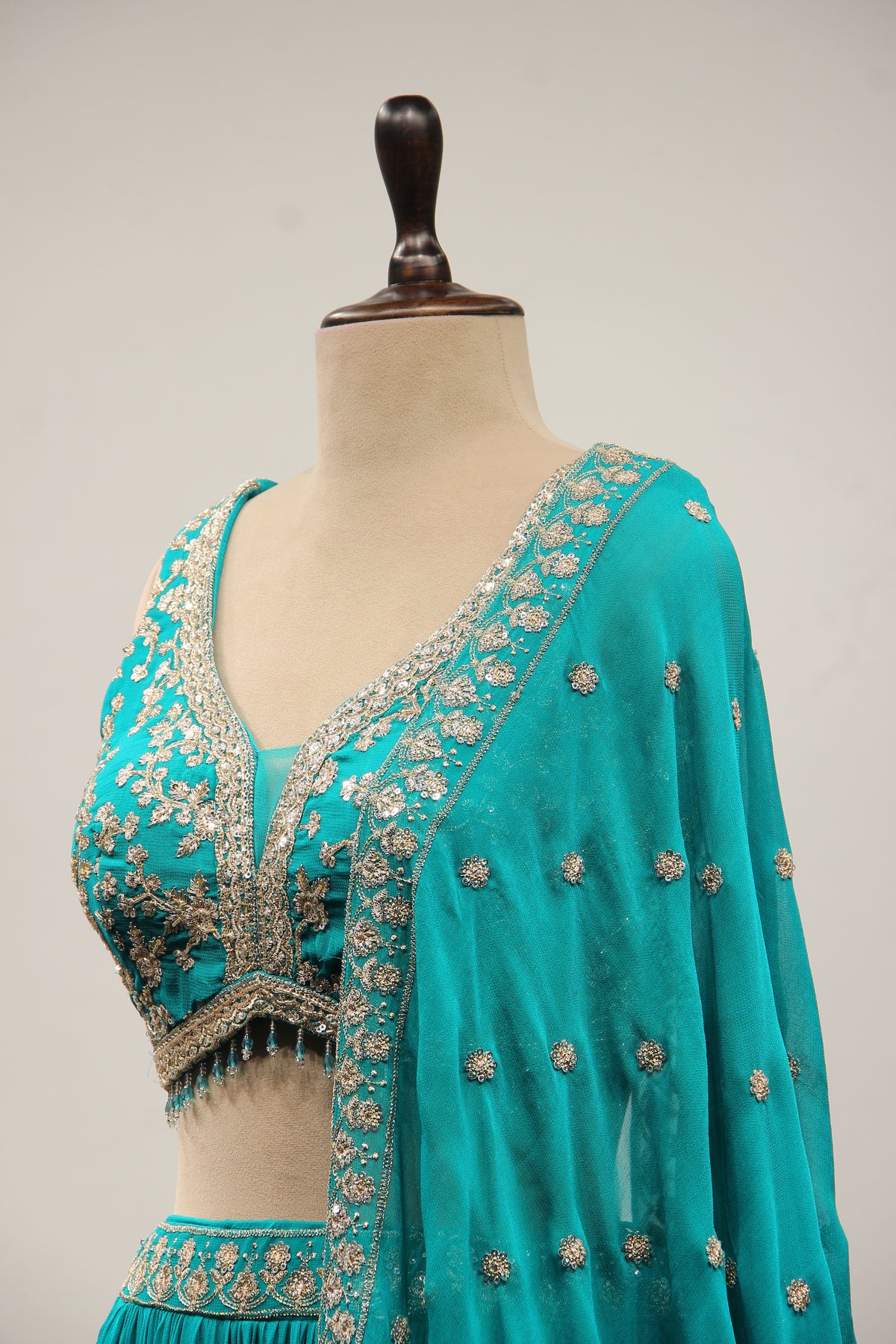 Georgette Lehenga with Zari & Sequin Handwork Plunge V-Neck Crop Top in Green – side close-up