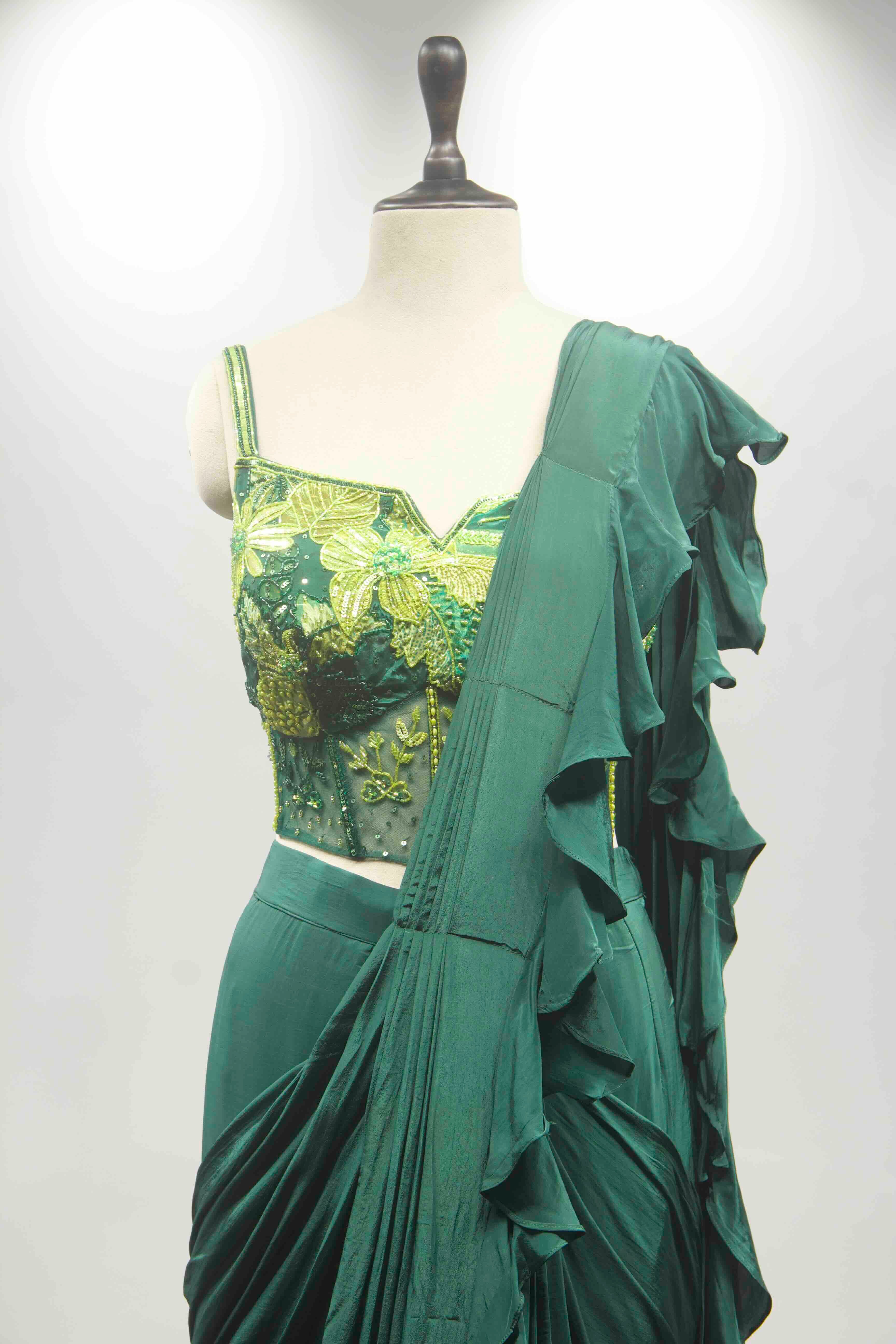 hand emb blouse green drape saree