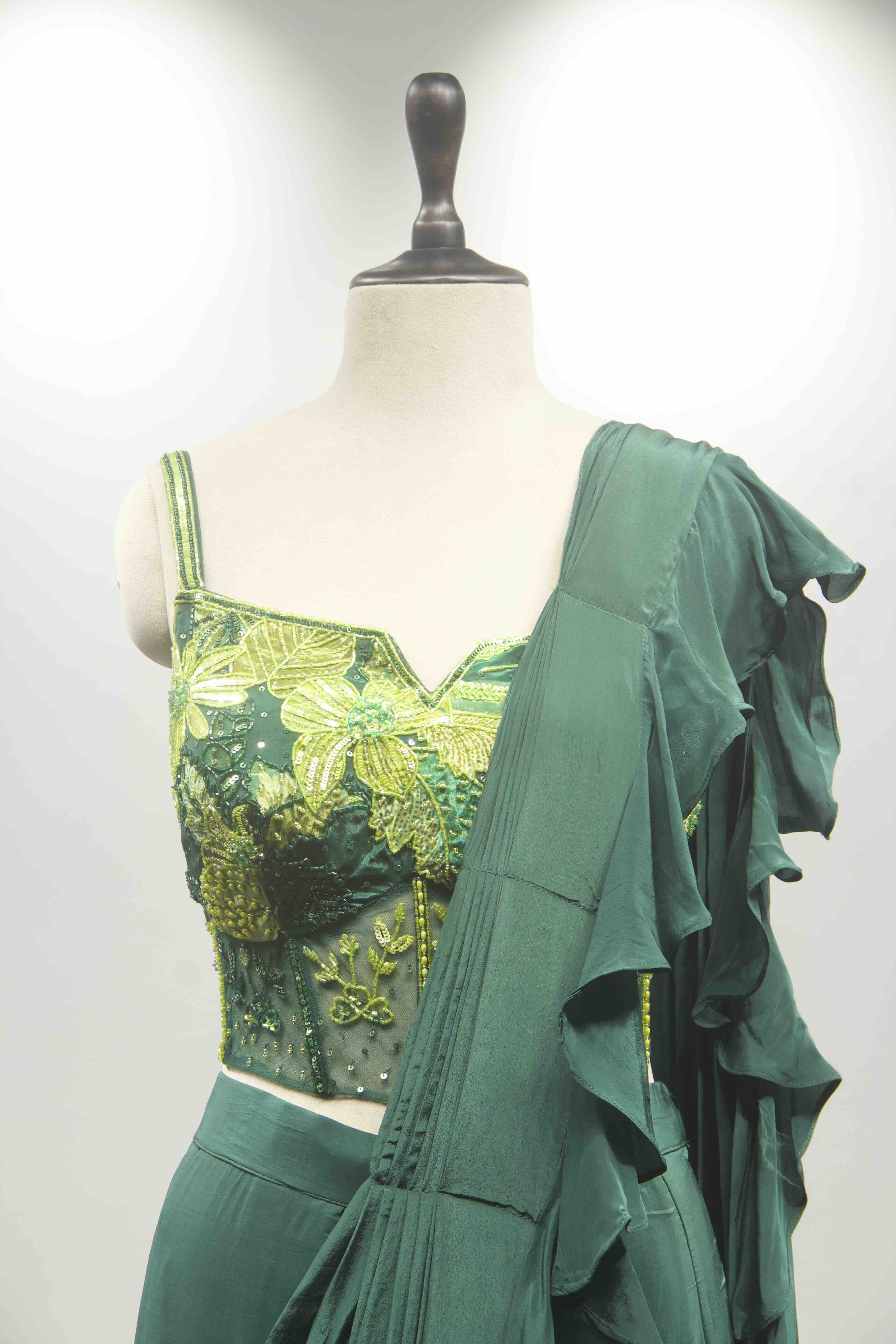 hand emb blouse green drape saree