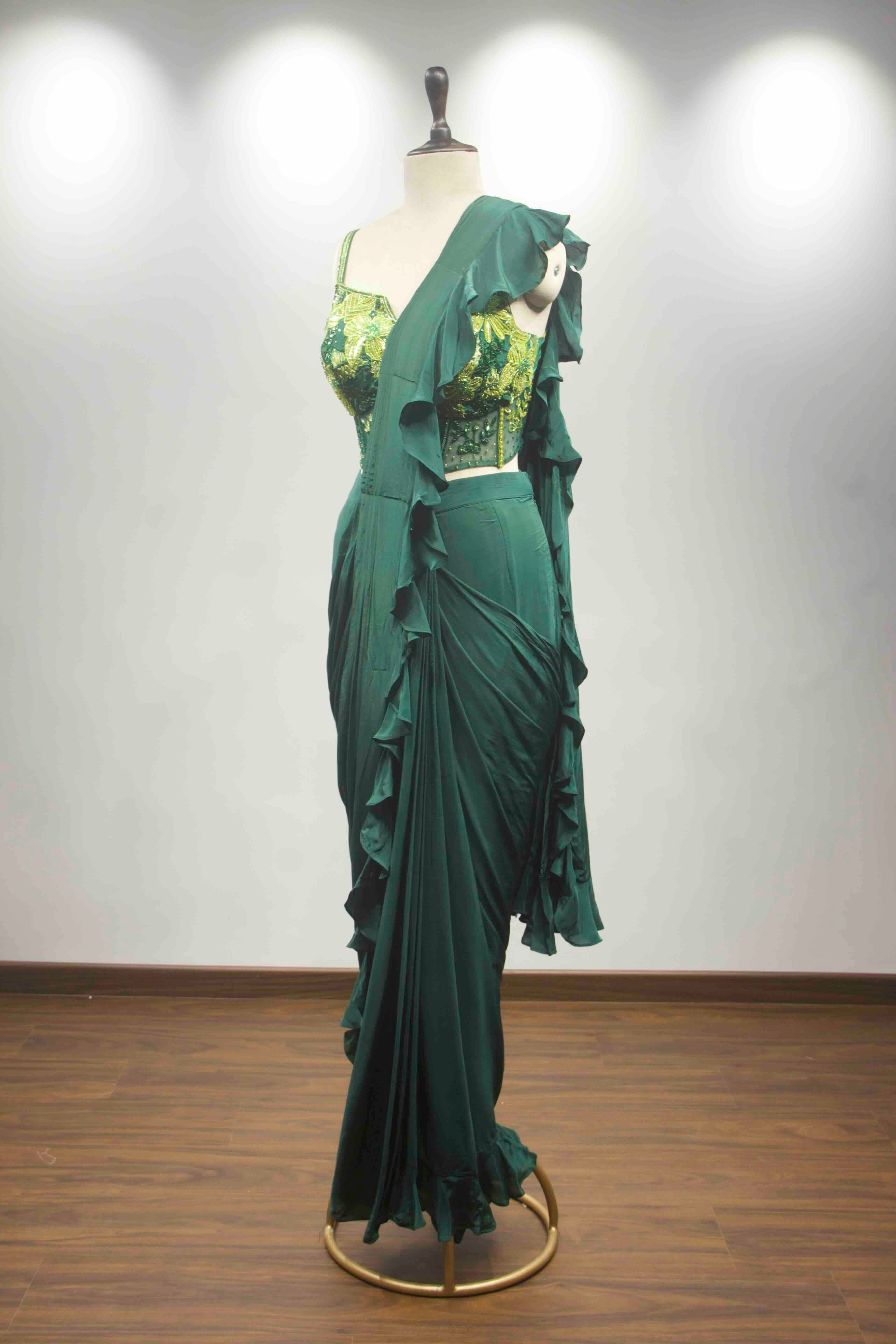 hand emb blouse green drape saree